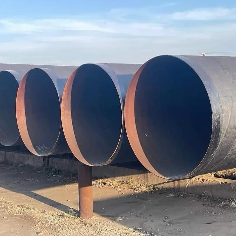 Tuberías metálicas de gran diámetro alineadas en un entorno exterior.